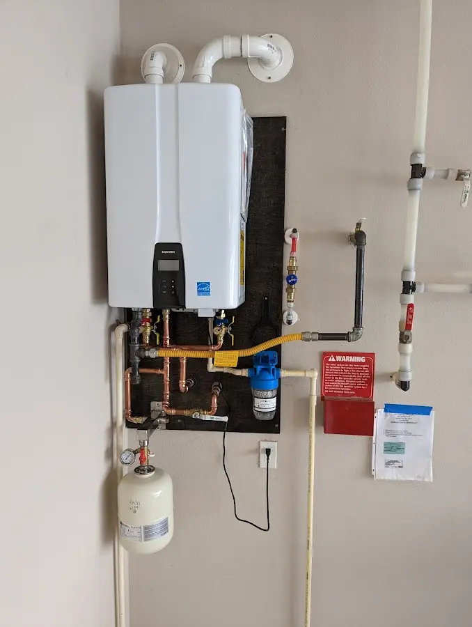 Professional plumber installing copper piping in a Running Springs home